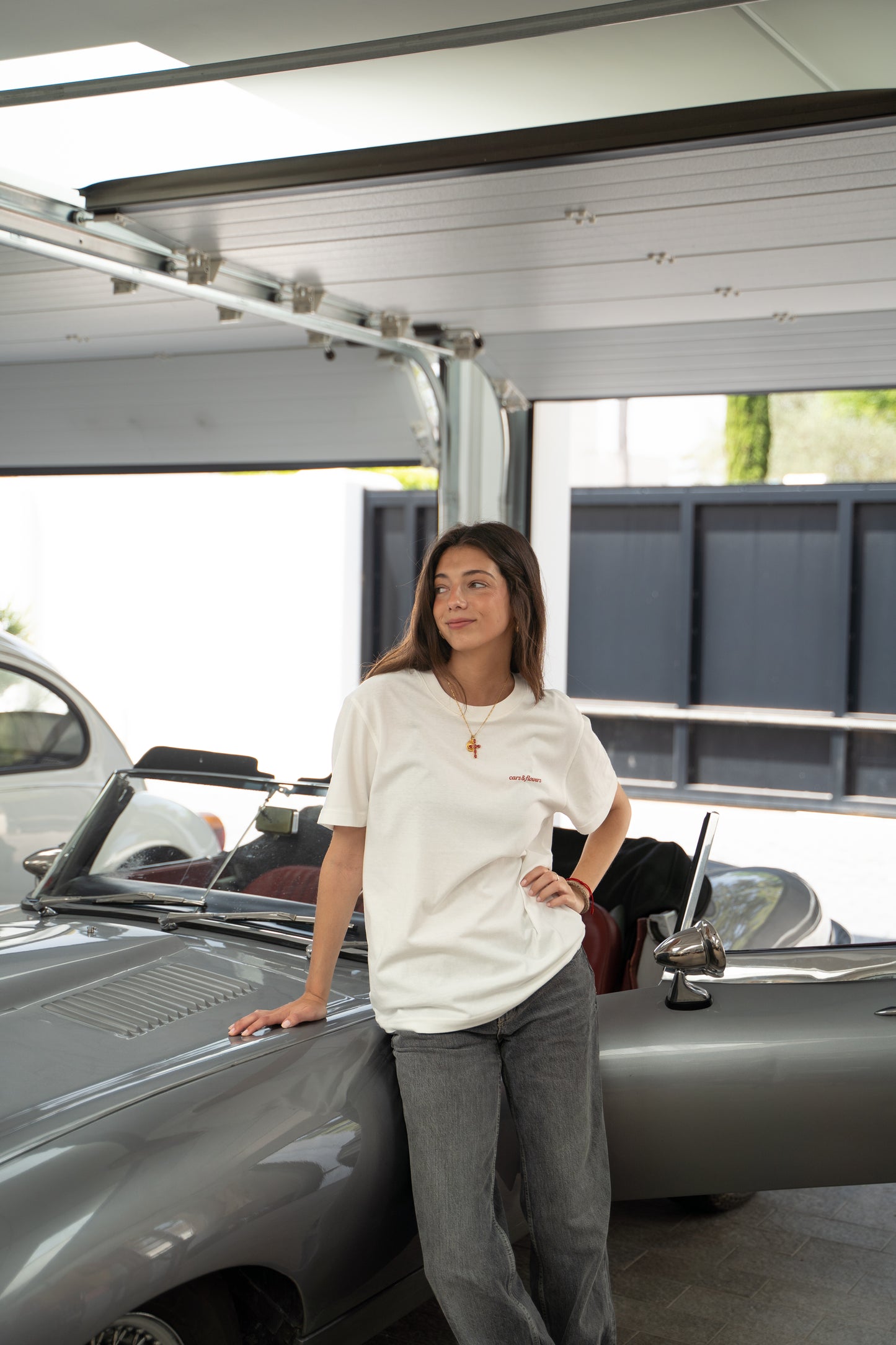 Woman model standing next to a classic jaguar e-type