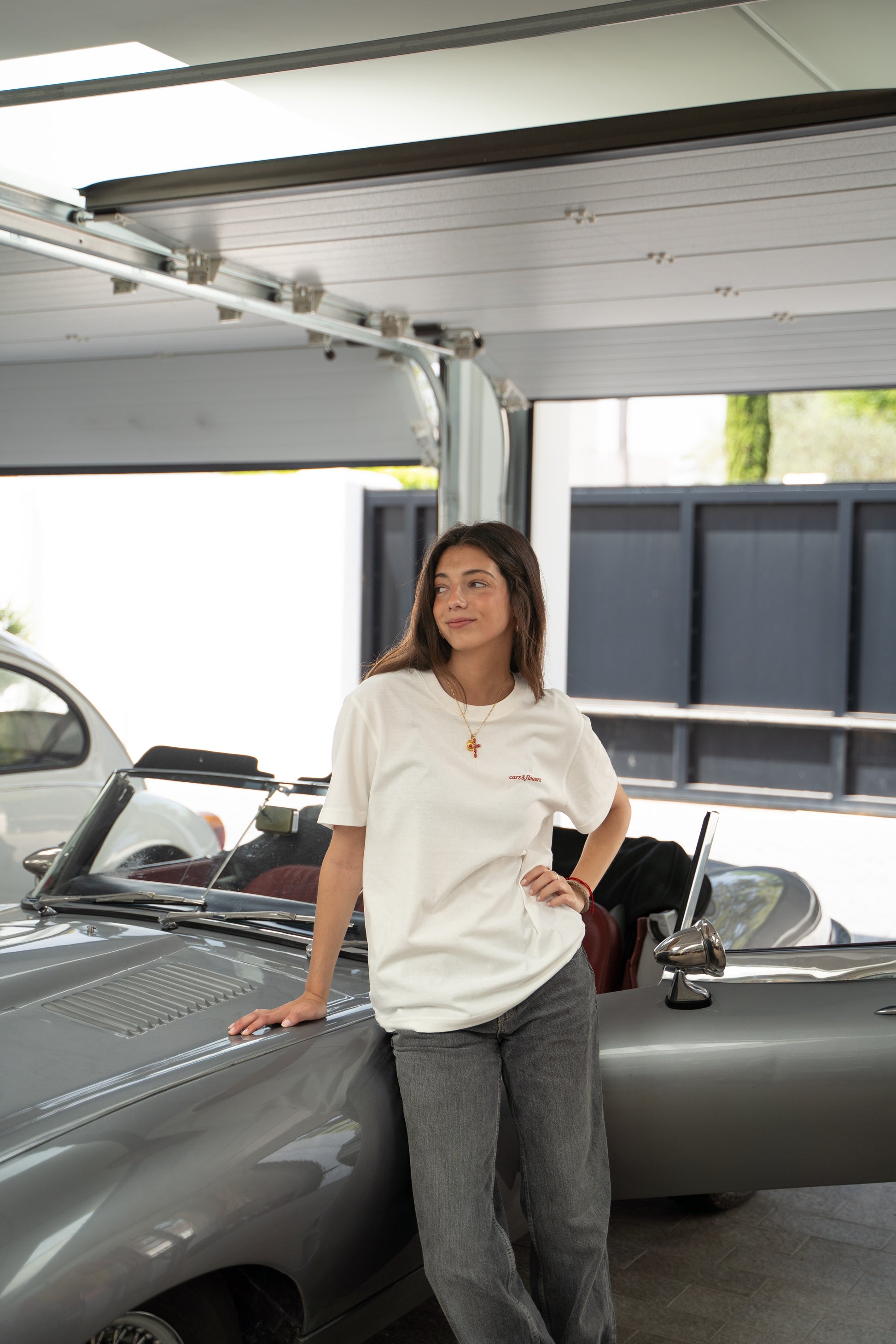 Woman  model standing next to a classic jaguar e-type